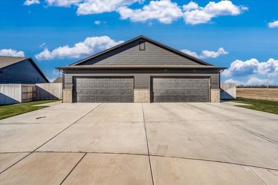 View of front facade featuring a garage and an outbuilding | Image 1