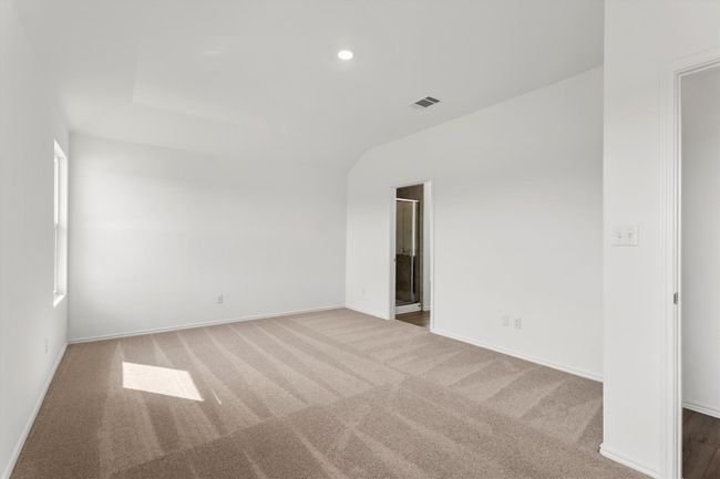 Carpeted spare room featuring vaulted ceiling and recessed lighting | Image 13