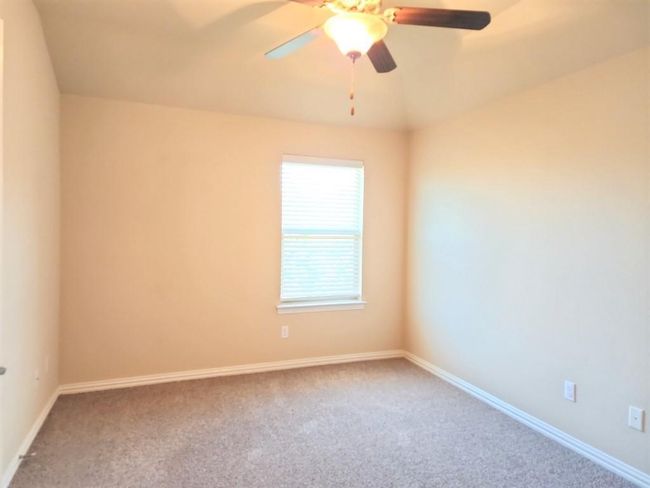 Spare room featuring carpet floors, ceiling fan, and baseboards | Image 16