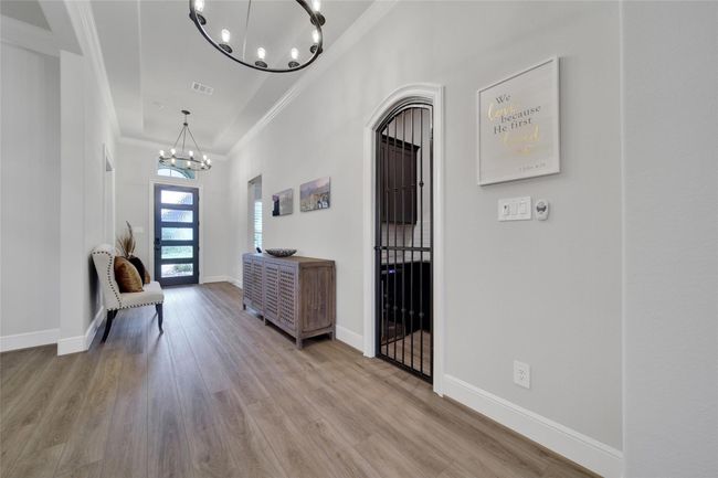 Striking full glass front door sets a modern tone and floods the entryway with natural light. | Image 4