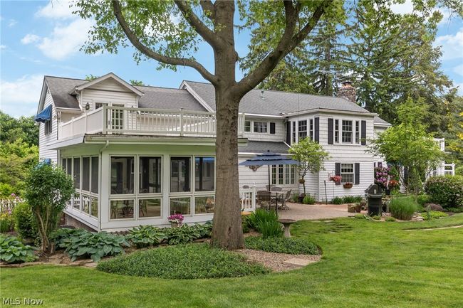 Back of house with a sunroom, a lawn, and a patio area | Image 10