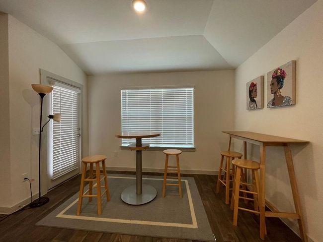 Dining room with wood finished floors, vaulted ceiling, and baseboards | Image 11