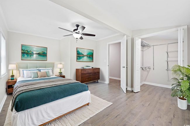 Bedroom with crown molding, baseboards, light wood-style floors, and a ceiling fan | Image 15