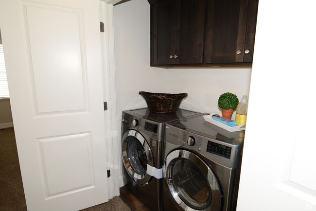 Laundry room featuring washer and clothes dryer and cabinet space | Image 13