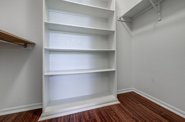 Spacious closet with wood finished floors | Image 27