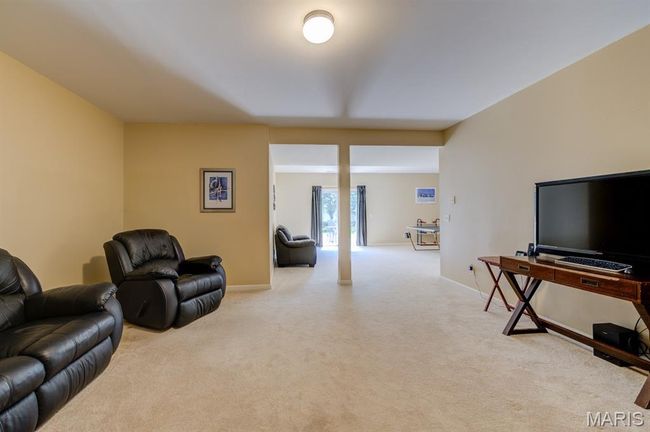 The basement has 720 square feet of finished space. This part of it could be a party room or movie room, or a place to hang out with company. | Image 28