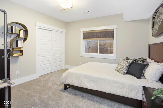 An additional lower level bedroom with an adjoining bath offers a private retreat for guests or extended family. | Image 11