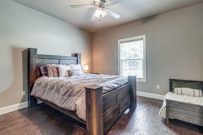 Bedroom featuring ceiling fan and dark hardwood / wood-style flooring | Image 16
