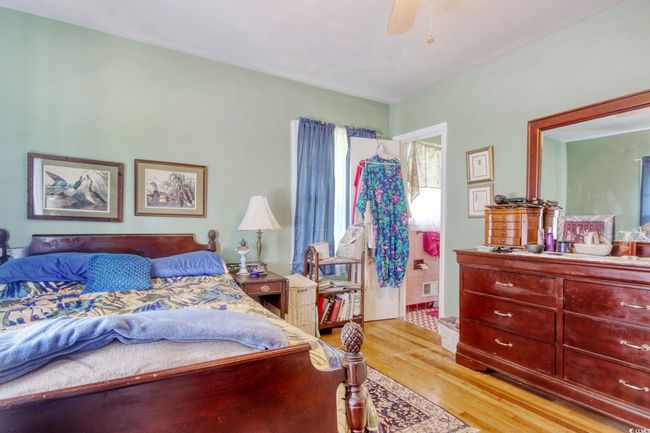 Bedroom featuring light wood-style floors and a ceiling fan | Image 27