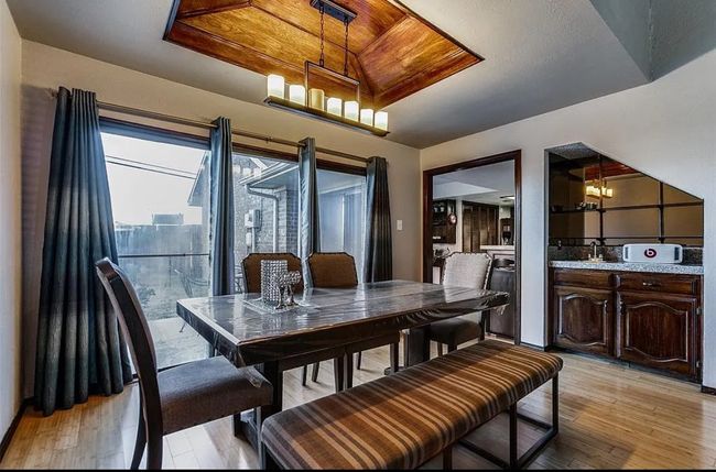 Dining area featuring light wood-style flooring and a chandelier | Image 4