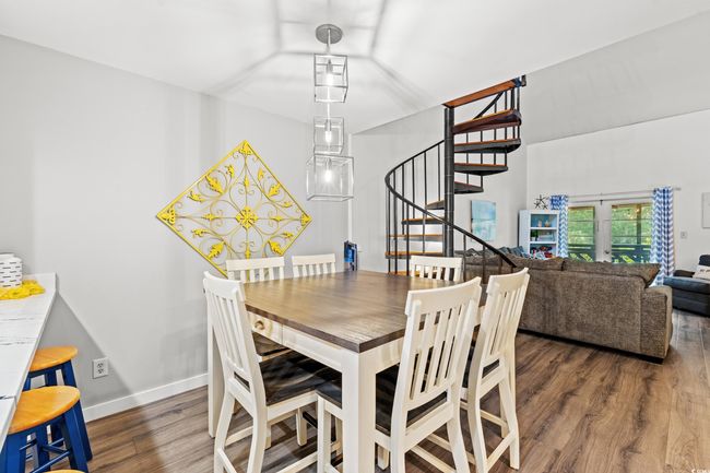 Dining room featuring stairs, wood finished floors, and baseboards | Image 7