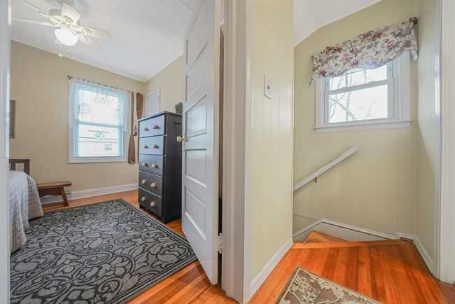 Corridor featuring an upstairs landing, baseboards, and light wood-type flooring | Image 14