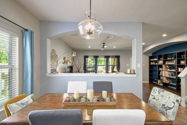 The dining area is accentuated by a charming overhead light fixture and a large window. | Image 14