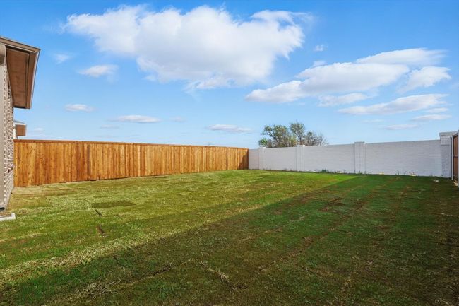 View of yard with a White Brick fenced backyard | Image 22
