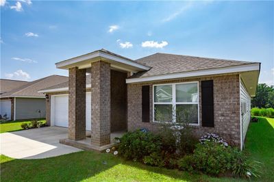 View of front of home featuring a garage and a front lawn | Image 1