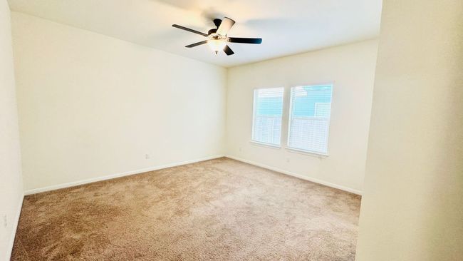 Carpeted spare room with baseboards and ceiling fan | Image 22