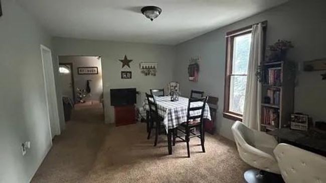 Dining area featuring carpet flooring and a wealth of natural light | Image 9