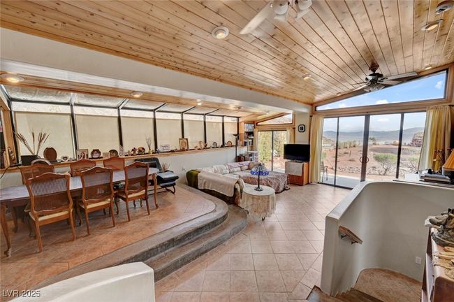 Bedroom with tile patterned floors, wood ceiling, vaulted ceiling, and access to exterior | Image 16
