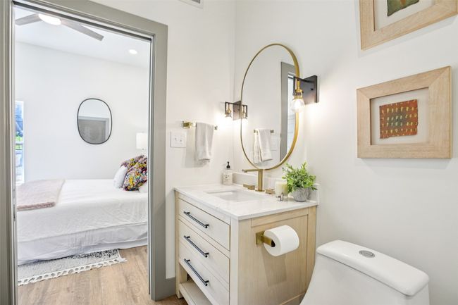Bathroom featuring vanity, light wood-style flooring, and ensuite bathroom | Image 20