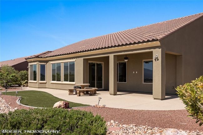 Back of house featuring a tiled roof, a ceiling fan, a patio, and stucco siding | Image 60