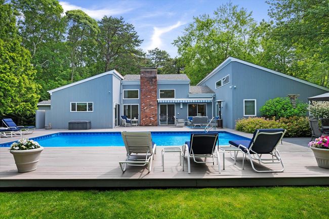 Outdoor pool with a deck, a lawn, and a jacuzzi | Image 31
