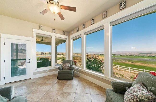 Sunroom featuring a rural view and tile patterned floors | Image 16