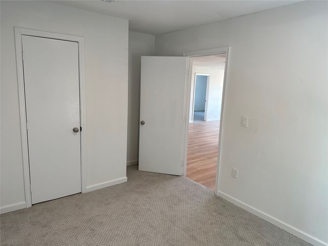 Unfurnished bedroom with carpet flooring and baseboards | Image 21