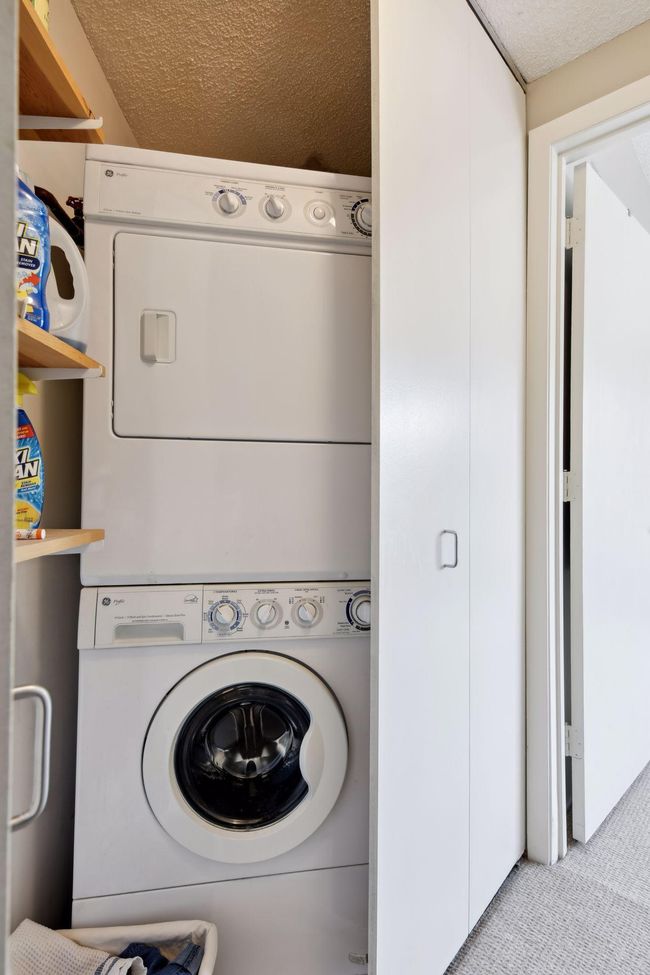 In unit washer and dryer with convenient shelving. | Image 18