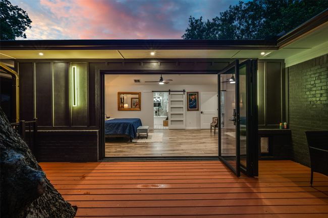 Deck at dusk featuring a sunroom | Image 35