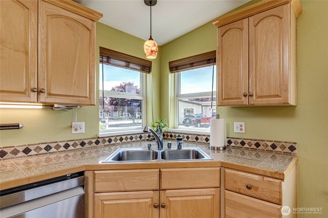 Sunny windows at corner sink. | Image 15