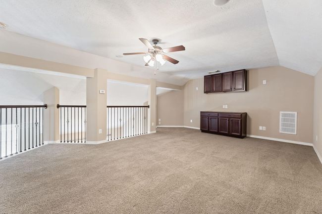 Bonus room upstairs with ceiling fan and built-in cabinets. Perfect for a play room, poker area, office space, and many other possibilities! | Image 36