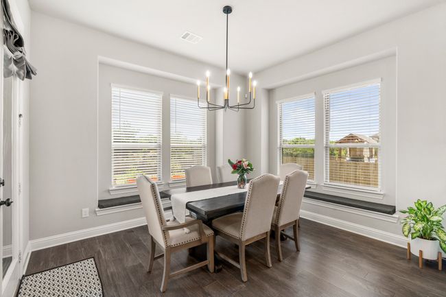 Dining space with a chandelier and dark wood finished floors | Image 16