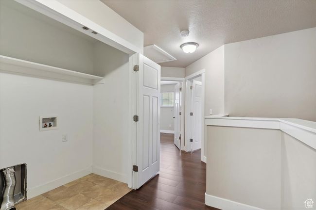 Laundry room featuring hookup for a washing machine, a textured ceiling, baseboards, and wood finished floors | Image 14