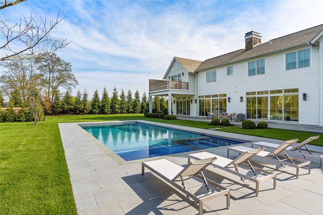 Swimming pool with a patio area and a lawn | Image 44