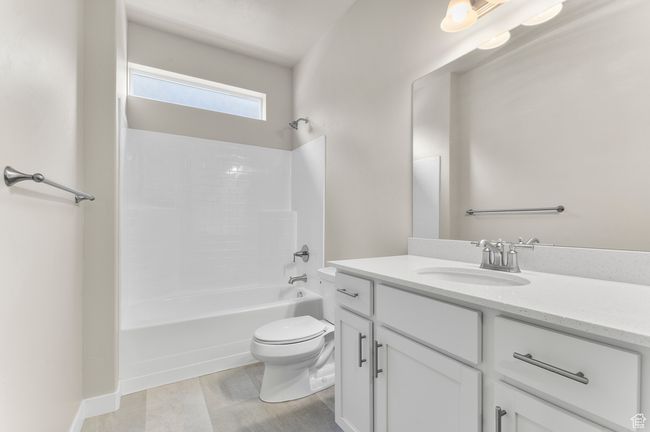 Bathroom with toilet, bathing tub / shower combination, and vanity | Image 7