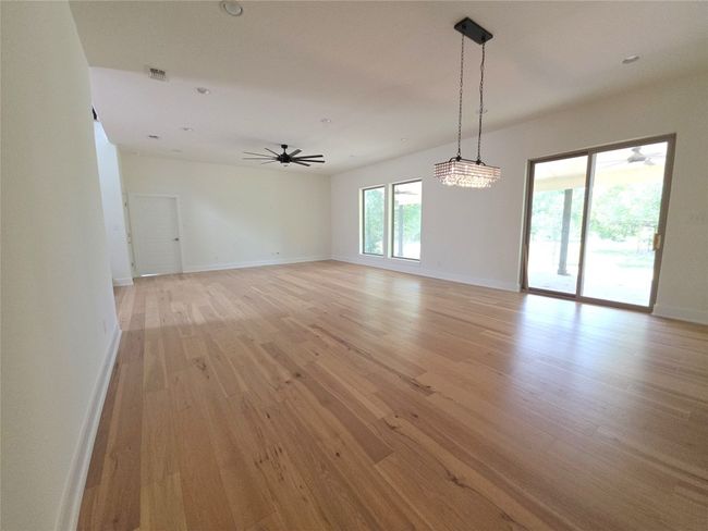 Unfurnished room featuring light wood-type flooring, baseboards, ceiling fan, and recessed lighting | Image 12
