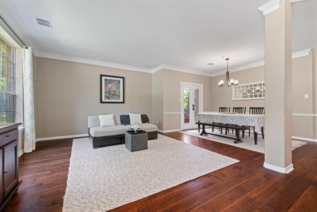Tucked just inside the front entry, this secondary living space offers a quiet corner for conversation, reading, or creating a music room that feels as peaceful as it looks | Image 5