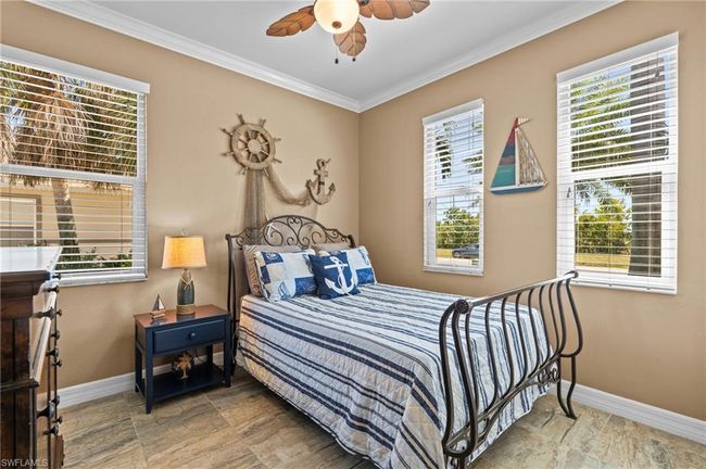 Bedroom with baseboards, crown molding, and ceiling fan | Image 29