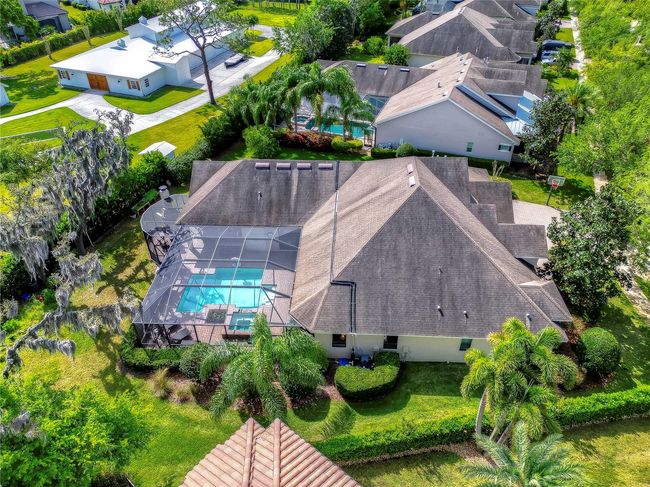 The lush landscaping and serene neighborhood make this property a true oasis for relaxation and leisure. | Image 42