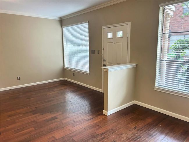 Enjoy a little separation from the dining room with a small half wall. There is lots of natural light floods the windows, even with all the beautiful shady landscaping outside! It's the best of both worlds. | Image 16
