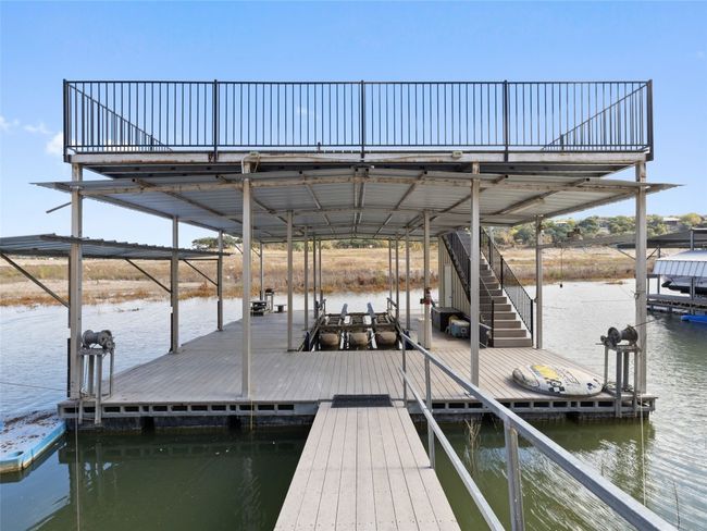 The 2 level boat slip has a lift, a jet ski platform, a storage closet and lots of space to enjoy the lake in the sun and the shade. Water is navigable by jet ski out to the main body of the lake. | Image 12