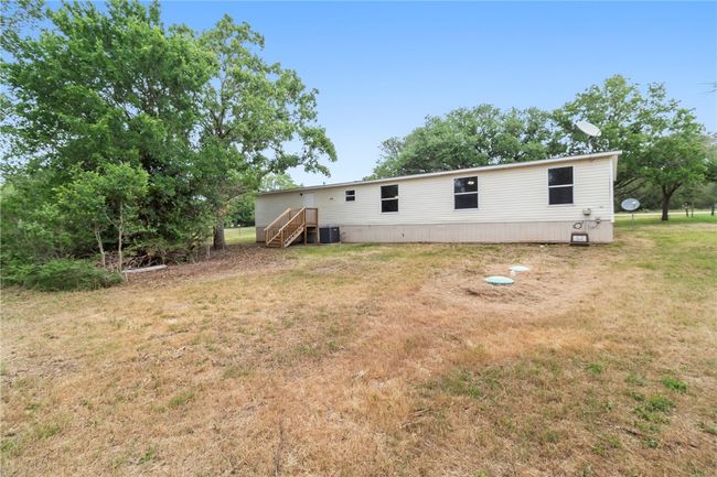 Rear view of property with a yard and central air condition unit | Image 13