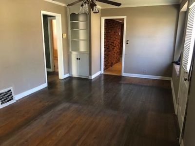 Living room with ornamental molding, ceiling fan, and dark wood-type flooring | Image 3