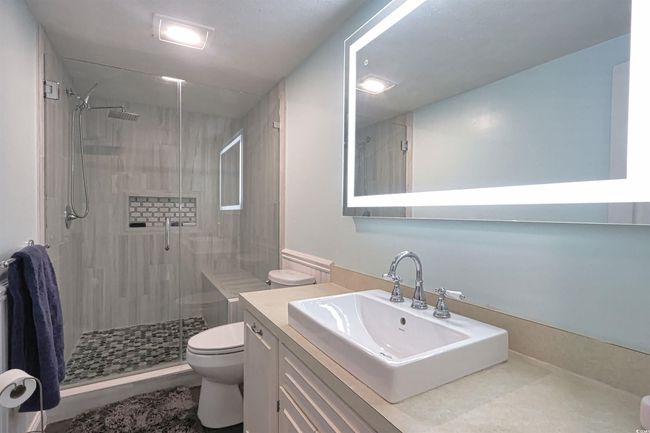 Bathroom featuring a shower stall and vanity | Image 20