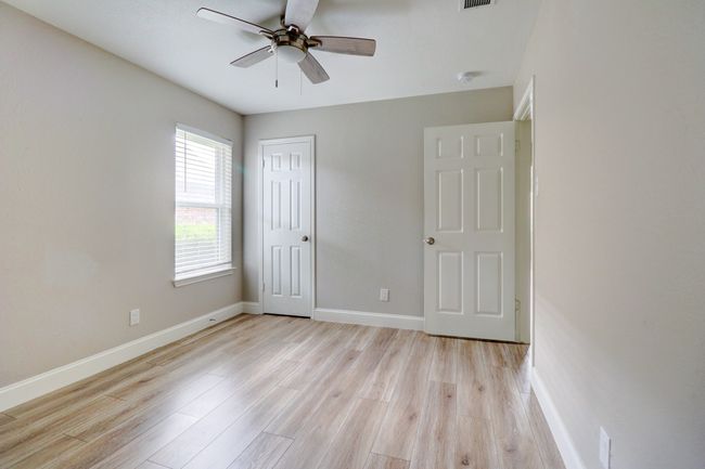 Unfurnished bedroom featuring light wood-style flooring, a closet, and ceiling fan | Image 21