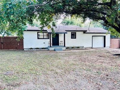 Ranch-style house featuring a front lawn and a garage | Image 2