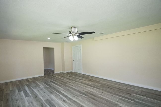 Primary room featuring wood finished floors, ceiling fan, and recessed lighting | Image 16