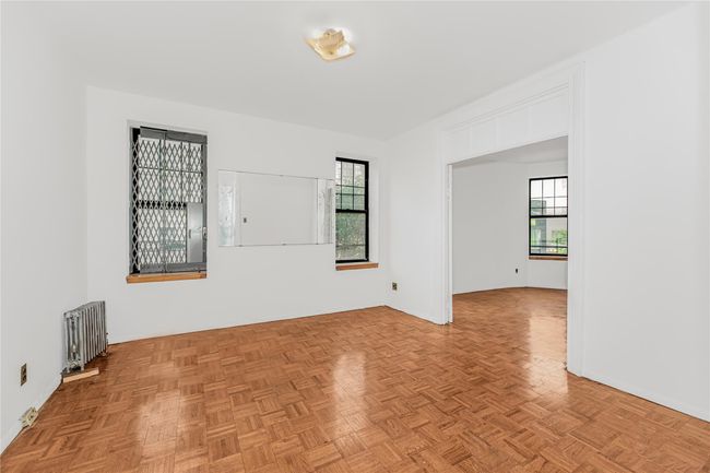 Unfurnished room featuring radiator heating unit and healthy amount of natural light | Image 14