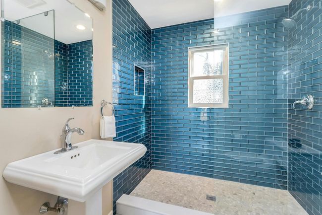 Completely renovated full bath on the first floor with beautiful glass tiles. | Image 10