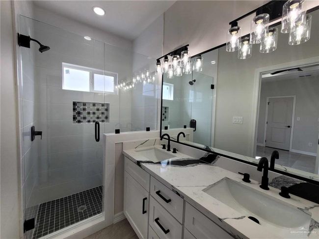 Bathroom with vanity, an enclosed shower, and tile patterned floors | Image 19